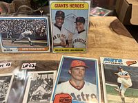 Photo of seven vintage baseball cards laid out showing players such as Tom Seaver, Nolan Ryan, Willie McCovey, Juan Marichal, Lou Brock, and others