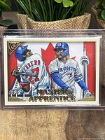 Front of the 2019 Topps Gallery Master and Apprentice baseball card showing illustrated art of Vladimir Guerrero and Vladimir Guerrero Jr. with Canadian flag background.