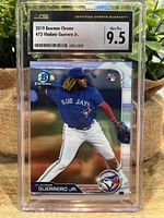 Photo of the card encased in a CSG graded holder showing front with Vladimir Guerrero Jr in Blue Jays uniform pitching.