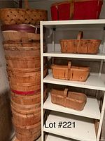 Photo of the lot showing multiple apple picking baskets stacked and on shelving