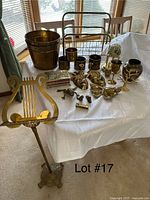 Table display with brass decor pieces against a window