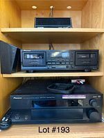 Shelf with Pioneer dual cassette deck and Pioneer multi-channel receiver