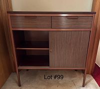 Front view of wood hall table with metal frame showing two drawers, cabinet door, and shelves