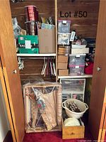 Wide view of closet shelves showing bins, boxes, fabric rolls, embroidery frame, thread caddy and drawer