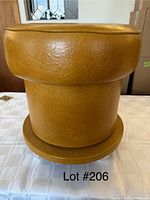 Yellow retro styled storage stool showing full exterior with textured mustard vinyl material.