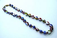 Complete view of the 16-inch Murano Millefiori bead necklace showing colorful individually knotted beads and barrel clasp.
