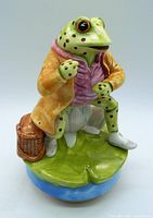 Front view of Jeremy Fisher frog music box figurine showing detailed painting and posture on lily pad base with basket