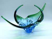 Oblique front view of the blue and green vintage stretch art glass basket showing the smooth stretched elongations and flow of colors.