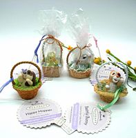 Four Hallmark Keepsake Easter ornaments, each in woven basket style, two wrapped in plastic, each with original tags.