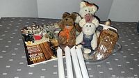Three Boyds Bears stuffed bears, an amber carnival glass jar with lid, four white battery operated pillar candles, a primitive lifestyle magazine, and a Peter metal serving tray.