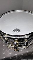 Top view of the snare drum showing the Remo coated drumhead and part of the chrome shell.