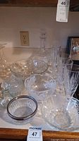 Photo of all crystal glassware including wine decanter, stemware, candy dishes, oil carafe, and serving bowls.