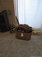 Black folding fireplace screen next to fireplace, partial view
