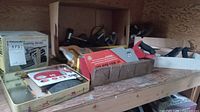 Wood hand saws, boxed Craftsman finishing sander, wood planer, and sandpaper on a wooden shelf