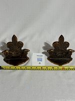 Pair of solid brass Boy Scouts of Canada Beavers book ends side by side with measuring tape below showing approx 6 inches width each