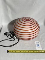 Lamp off, horizontal view showing swirl pattern and cord