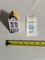 Top view of the Delftware canal house with measurement tape showing approx 3.5 inch height.