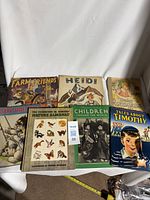 Photo showing seven vintage children's books arranged, titles include "Farm Friends," "Heidi," "Tales About Animals," "Story Time," "Nature Almanac," "Children Around the World," and "Tales About Timothy."