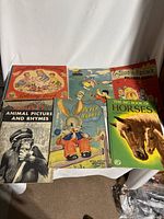 Lot of six vintage children's books laid out showing covers with animal themes, coloring book, and classic stories from 40s and 50s.