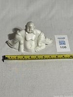 Top view of white jade Buddha showing width measurement around 6 inches.