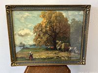 Front view of the framed farm landscape art print showing the pastoral scene of a large tree, cattle, and a figure in traditional dress.