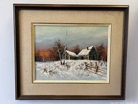 Framed oil painting showing snowbound barn with trees and snow on ground, signed H Fredricks at bottom right.