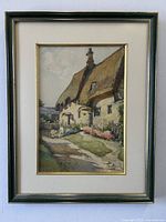 Frontal view of the framed watercolour painting showing the thatched cottage scene.