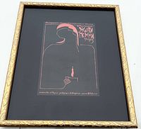 Framed poster tilted against a wall showing abstract silhouette and Cyrillic text.