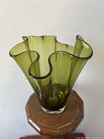 Green Scandinavian blown glass vase shown from multiple angles highlighting ruffled handkerchief rim