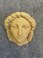 Front view of the stone lady head wall vase showing detailed facial features and textured stone material.