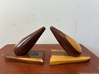 Pair of wooden bookends showing side angle with two tone wood color and pointed upright piece