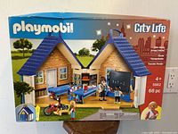 Front view of unopened boxed Playmobil City Life Take Along Schoolhouse set showing graphics, item count and age recommendation.