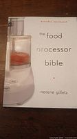 Cover photo of 'The Food Processor Bible' cookbook by Norene Gilletz showing white background with food processor image.