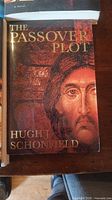Close-up of The Passover Plot by Hugh J Schofield book cover featuring a stylized face image.