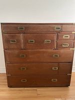 Front view of antique Korean elm dresser showing drawer layout and brass recessed handles.