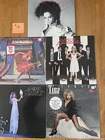 Five vinyl albums laid out on floor, showing front covers of Blondie Parallel Lines, Tina Turner Private Dancer, Stevie Nicks Bella Donna, Diana Ross Swept Away, and Cyndi Lauper She's So Unusual.