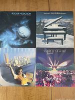 Top-down photo showing four vinyl album covers arranged in a 2x2 grid: Roger Hodgson's In the Eye of the Storm, Supertramp's Even in the Quietest Moments, Supertramp's Breakfast in America, and Supertramp Paris double album.