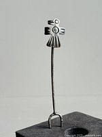 Front view of the entire sterling silver raven pin showing the full length and forked bottom fastener.