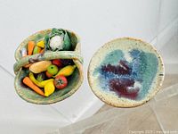 Top and side view of miniature pottery basket filled with colorful miniature vegetables and a small abstract glazed pottery plate.