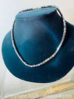 Full view of vintage hematite rectangular beaded necklace displayed on black jewelry bust.