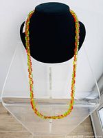 Full view of the necklace displayed on a black bust stand showing the complete 20.75 inch length and color pattern.