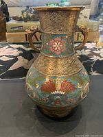 Front view of the antique bronze cloisonne vase showing floral patterns, geometric designs, and dragon handles.