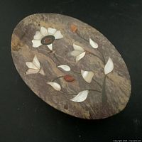 Top view of oval marble box lid with floral Pietra dura inlay.