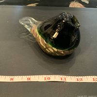 Glass bird figurine showing the side profile, placed next to a measuring tape indicating length of about 6 inches.