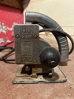 Front view showing label Wen All Saw Model 909 on the metal body of the jigsaw.