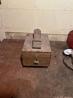 Closed solid wood shoe shine kit box with metal latch and handle on top