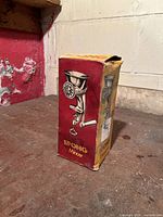 Photo of vintage Spong mincer in original box showing box front and side in worn condition.