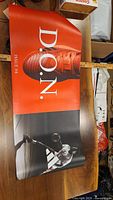Poster with large image of Adidas basketball shoe in orange and black with basketball player and D.O.N. Issue #4 text