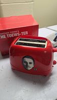 Red toaster with Jonathan Toews face decal and number 19 on side, showing front and side details.
