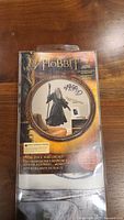 Front packaging showing The Hobbit branding and included Gandalf figure decal.
